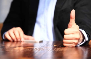 Man in suit giving thumbs up