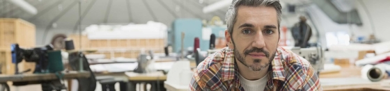 Portrait of confident worker in textile manufacturing plant.