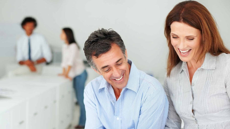 A man and woman employee discussing at office